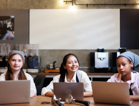 girls working and smiling at coffee