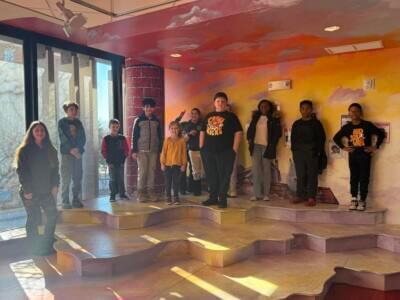 Kids standing in front of a wall