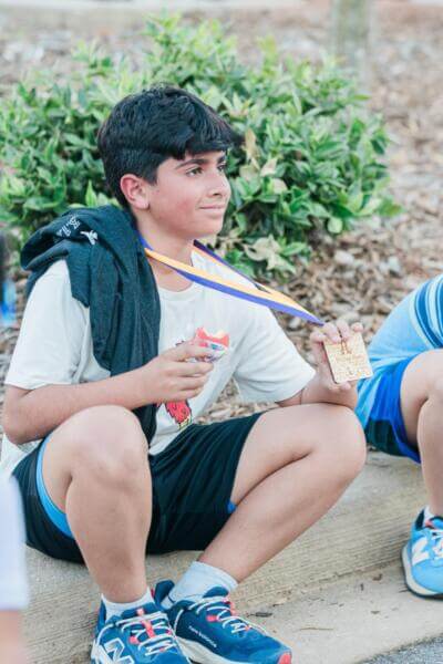 Boy holding a golden medal