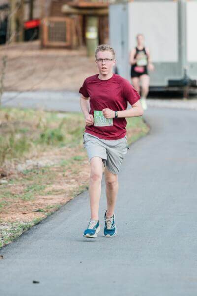 Boy wearing a red shirt running