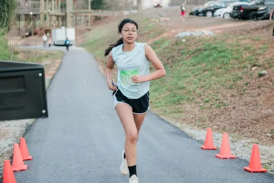 Girl running wearing the number 370 on her chest