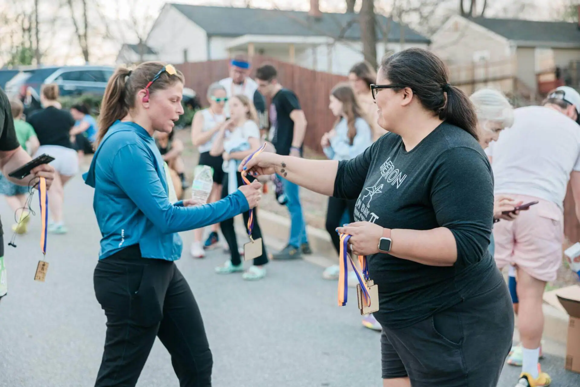 Girl in a black shirt sharing medals