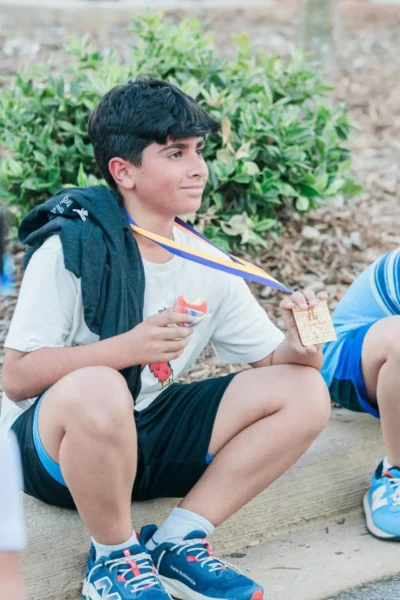 Boy holding a golden medal