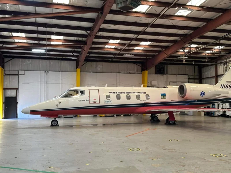 Private jet in a spacious hangar, labeled "Organ & Tissue Transport."