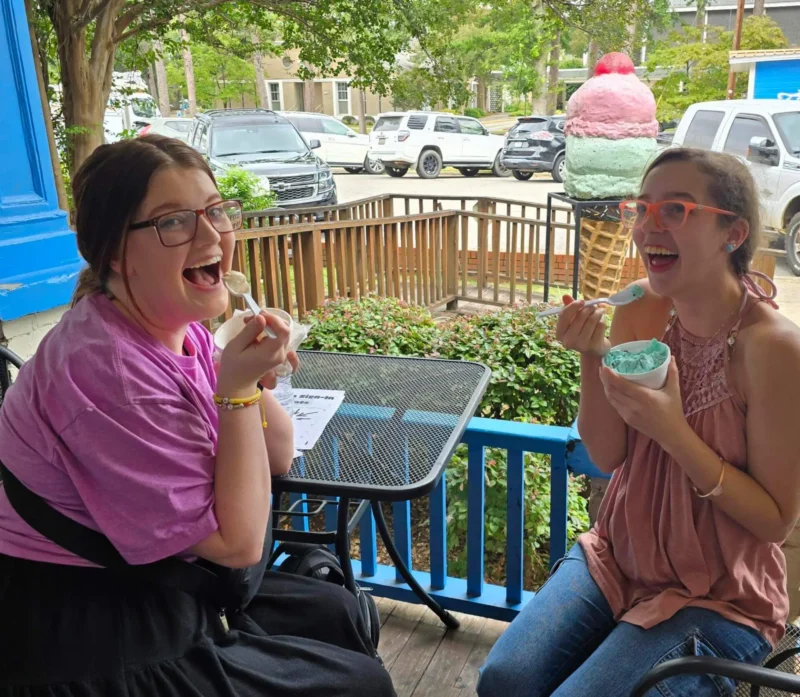 Two happy girls eating ice cream