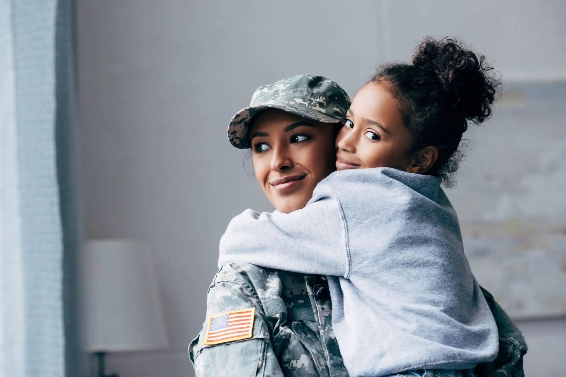 Mother wearing military uniform and her daughter